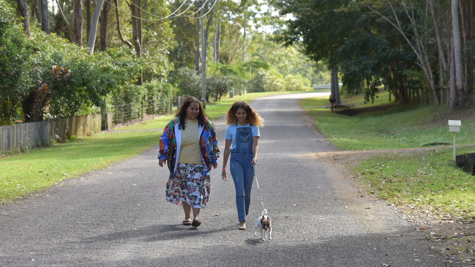 Mother and Daughter walking dog